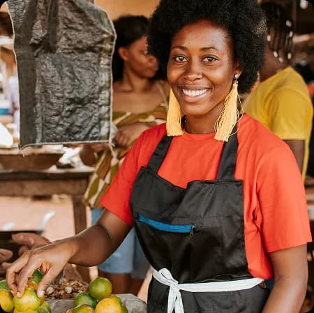 Merchant smiling at a market stall